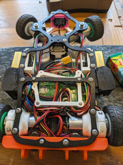 “bottom view of 3D printed chassis complete with all sensors and custom PCB”