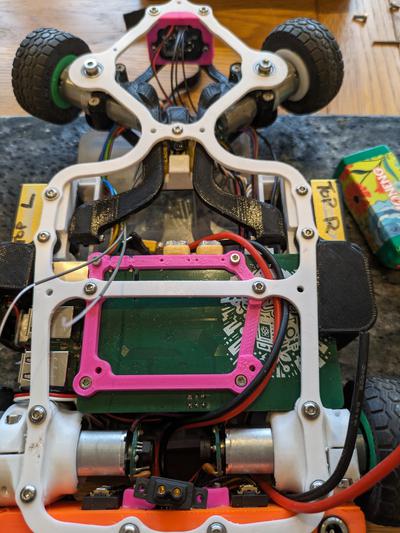 “top view of 3D printed chassis complete with all sensors and custom PCB”